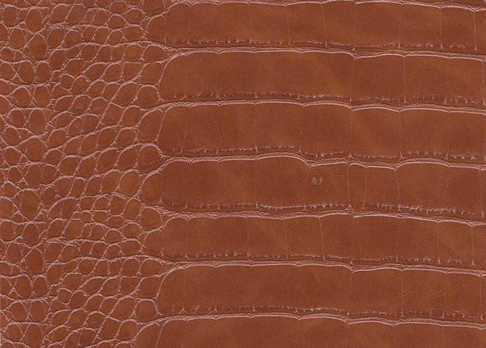Premium brown snake skin leather material with natural scale pattern. High-quality brown snake skin leather hide for luxury handbags. Brown snake skin leather sheet showing detailed texture and scales.